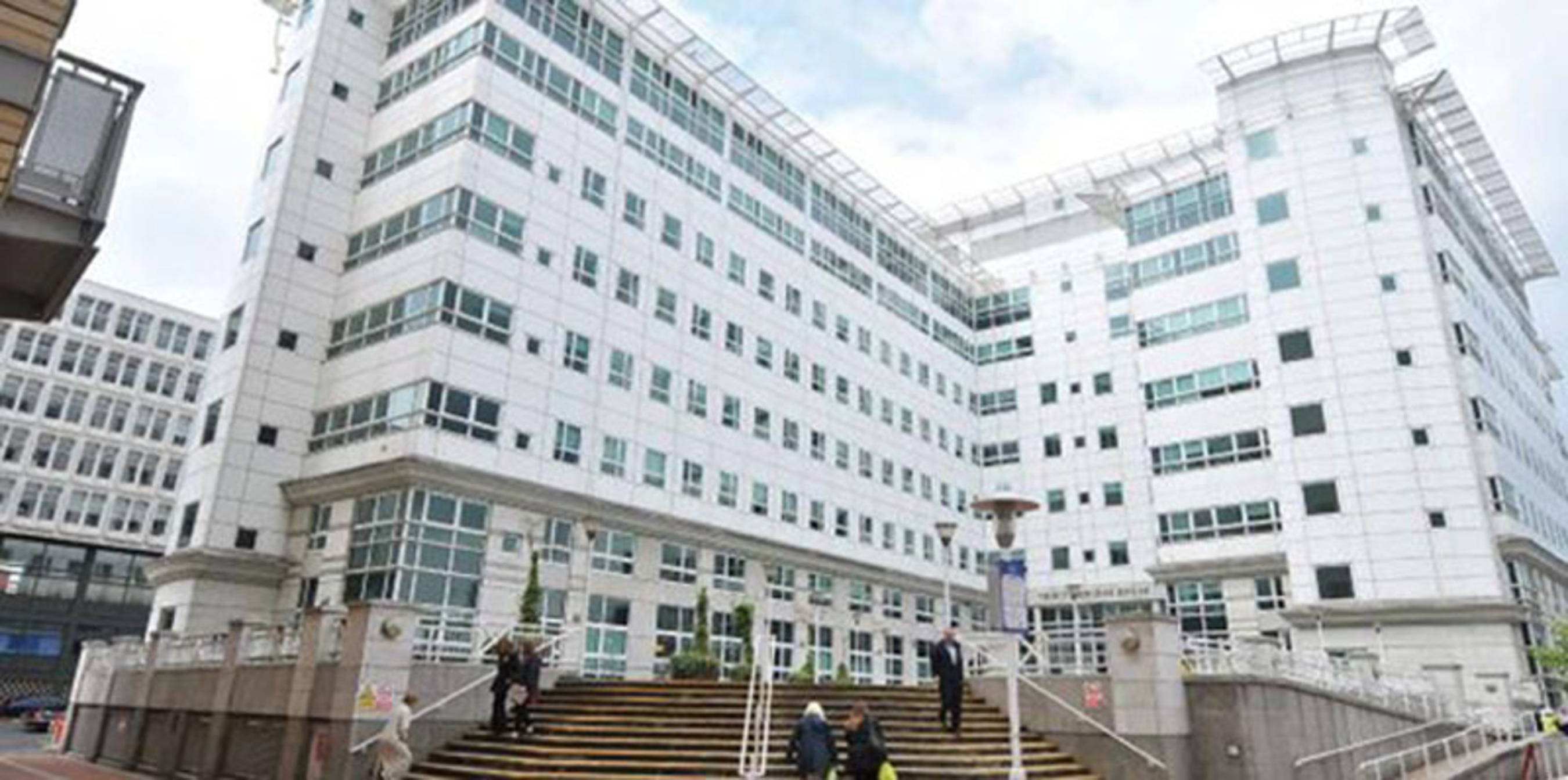 white building with people going up and down the stairs